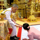 Queen Suthida prostrates herself before the king during the marriage ceremony.